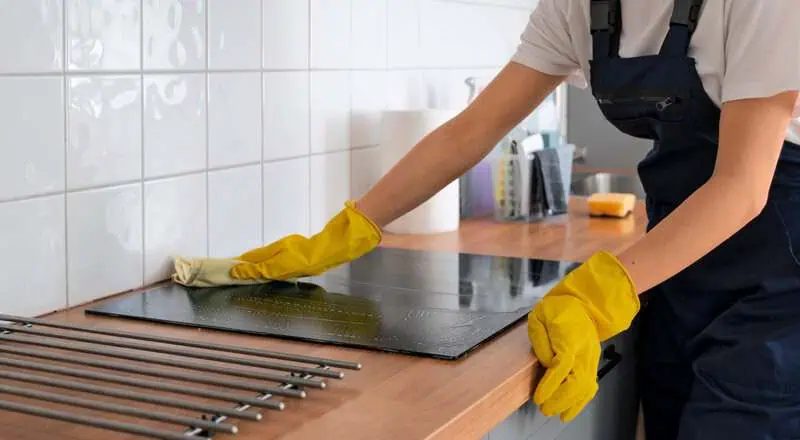 professional cleaner wiping kitchen surfaces during deep cleaning service